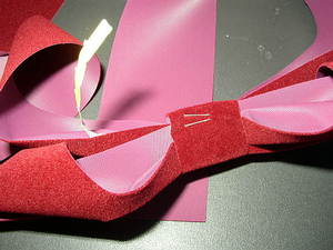 Work tie wrap in center of bow and tab